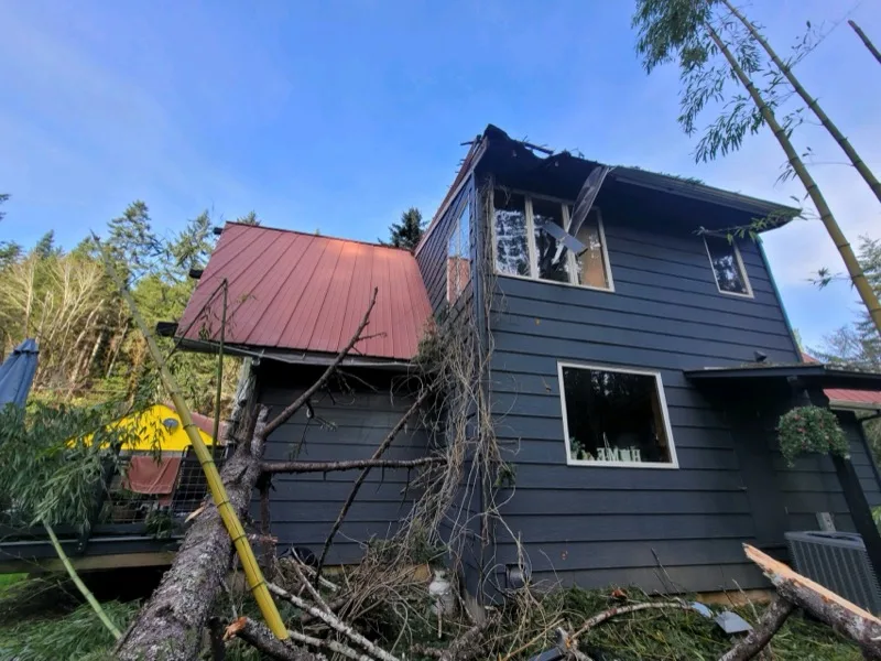 Storm damage to a home's roofline before OJEG restoration